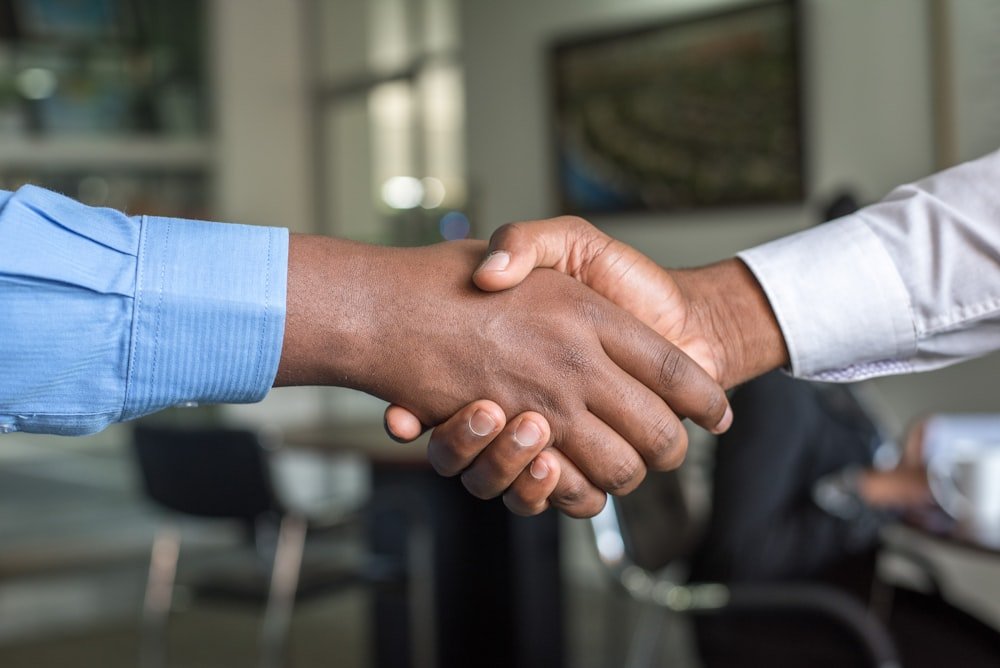 Insurance agent explaining policy to clients in a professional meeting